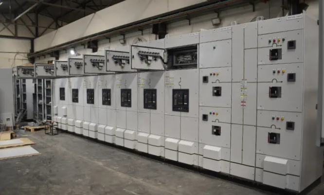 Engineers reviewing a resin reactor's control panel on the plant floor